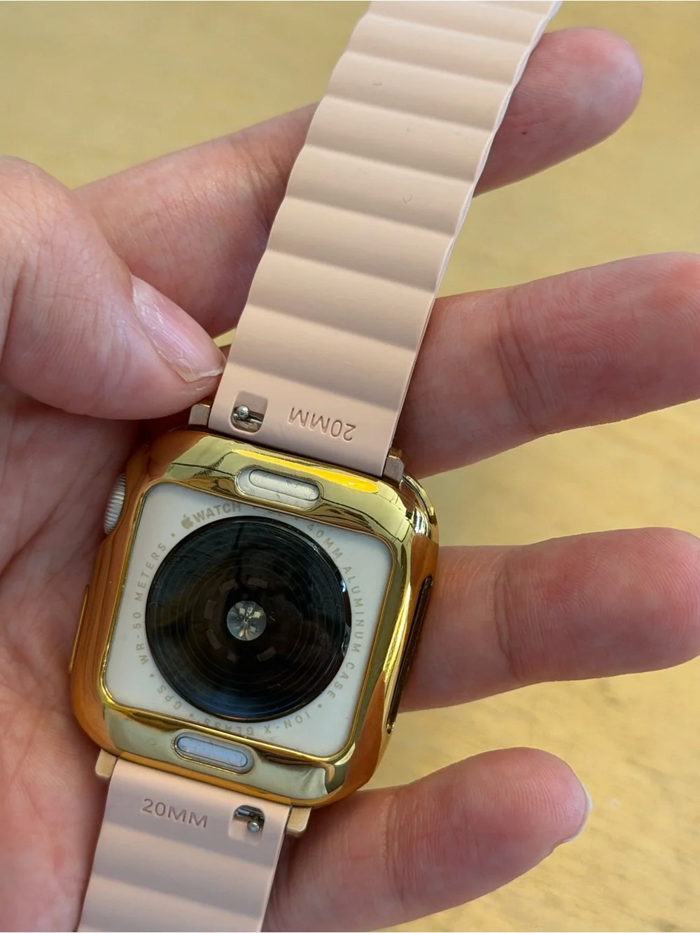 Apple Watch SE 40 mm Pink band and gold case included.